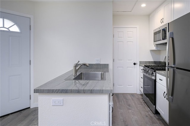 4781 Kona Kove Way, Yorba Linda, CA 92886 - kitchen with appliances with stainless steel finishes, dark wood-style floors, white cabinets, and recessed lighting