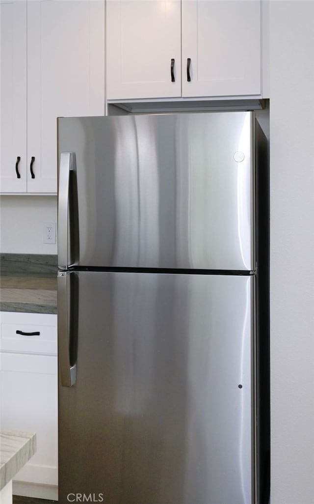 4781 Kona Kove Way, Yorba Linda, CA 92886 - detailed view of freestanding refrigerator, white cabinets, and wooden counters