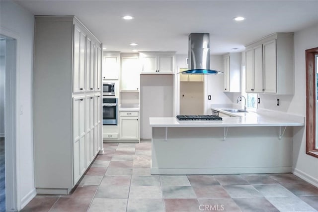 4781 Kona Kove Way, Yorba Linda, CA 92886 - kitchen with a peninsula, appliances with stainless steel finishes, wall chimney range hood, light countertops, and recessed lighting