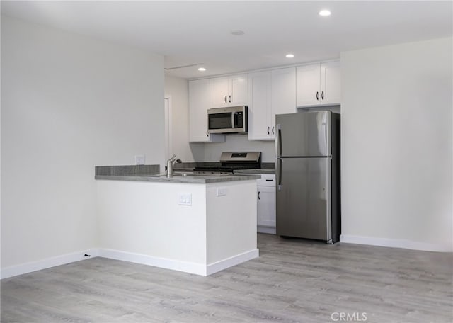4781 Kona Kove Way, Yorba Linda, CA 92886 - kitchen featuring appliances with stainless steel finishes, white cabinets, light wood-style flooring, a peninsula, and recessed lighting