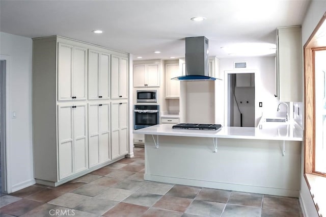 4781 Kona Kove Way, Yorba Linda, CA 92886 - kitchen with wall chimney range hood, stainless steel appliances, a peninsula, light countertops, and a kitchen bar