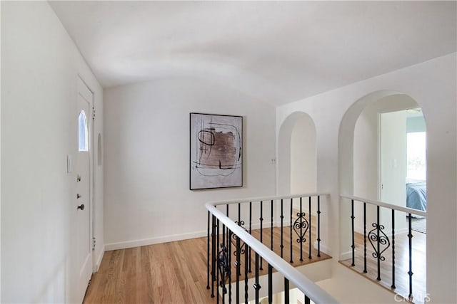 2982 Edgewick Rd, Glendale, CA 91206 - hall with lofted ceiling, light wood-style floors, an upstairs landing, and arched walkways