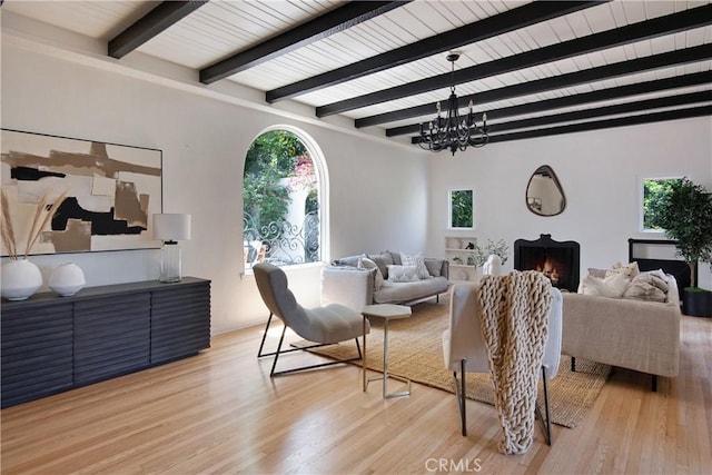 2982 Edgewick Rd, Glendale, CA 91206 - living room with light wood finished floors, beamed ceiling, a chandelier, and a lit fireplace