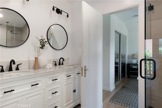 2982 Edgewick Rd, Glendale, CA 91206 - full bathroom featuring double vanity, a stall shower, and wood finished floors