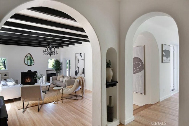 2982 Edgewick Rd, Glendale, CA 91206 - living room featuring beam ceiling, light wood-style floors, and a warm lit fireplace