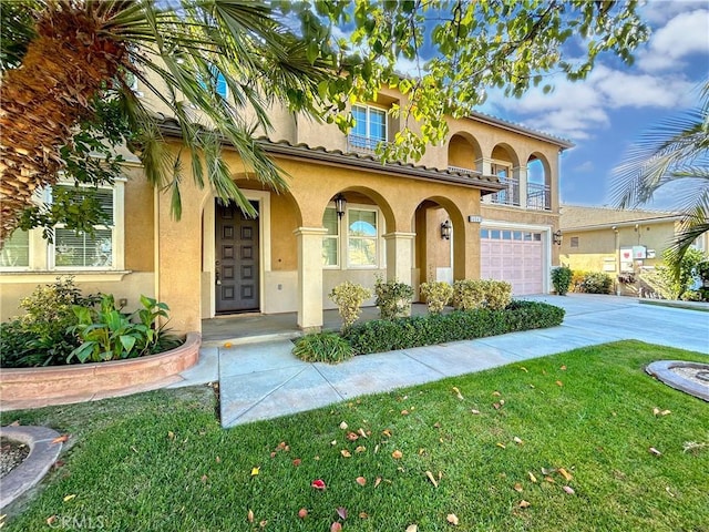 14145 Prairie Creek Pl, Eastvale, CA 92880 - mediterranean / spanish-style house with a garage, stucco siding, driveway, a front yard, and covered porch