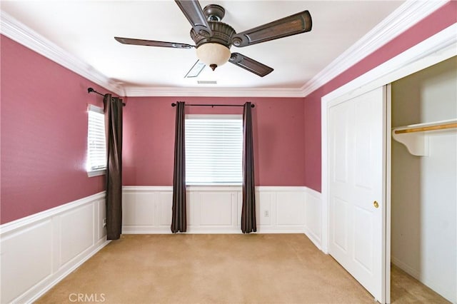 14145 Prairie Creek Pl, Eastvale, CA 92880 - unfurnished bedroom featuring light carpet, a wainscoted wall, a closet, crown molding, and ceiling fan