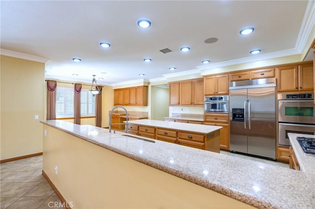 14145 Prairie Creek Pl, Eastvale, CA 92880 - kitchen featuring appliances with stainless steel finishes, crown molding, recessed lighting, light stone counters, and a center island