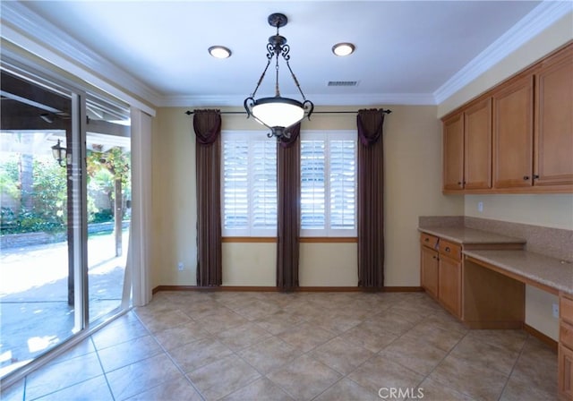 14145 Prairie Creek Pl, Eastvale, CA 92880 - unfurnished dining area featuring healthy amount of natural light, built in desk, ornamental molding, and light tile patterned floors