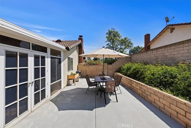 6807 Wilding Pl, Riverside, CA 92506 - fenced backyard featuring a patio area, outdoor dining area, french doors, and area for grilling