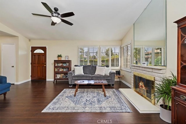 6807 Wilding Pl, Riverside, CA 92506 - living room featuring wood finished floors, ceiling fan, vaulted ceiling, and a glass covered fireplace
