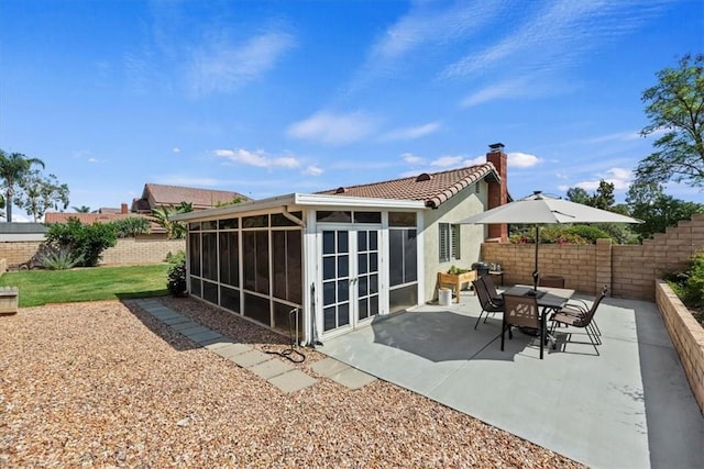 6807 Wilding Pl, Riverside, CA 92506 - back of property with a sunroom, a patio area, a fenced backyard, a chimney, and stucco siding