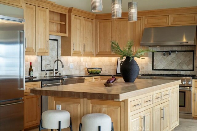 32131 Sea Island Dr, Dana Point, CA 92629 - kitchen featuring appliances with stainless steel finishes, under cabinet range hood, butcher block countertops, a kitchen island, and backsplash