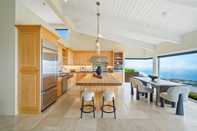 32131 Sea Island Dr, Dana Point, CA 92629 - kitchen featuring appliances with stainless steel finishes, wooden counters, open shelves, under cabinet range hood, and a breakfast bar