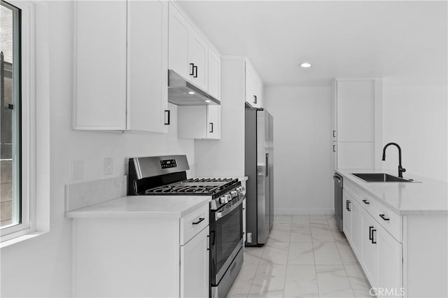 9019 Cedros Ave Unit 2, Panorama City, CA 91402 - kitchen featuring appliances with stainless steel finishes, under cabinet range hood, light marble finish floors, recessed lighting, and light countertops