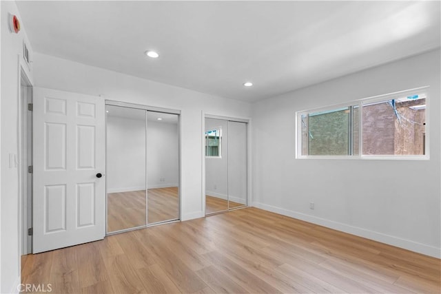 9019 Cedros Ave Unit 2, Panorama City, CA 91402 - unfurnished bedroom featuring multiple closets, light wood-style floors, and recessed lighting
