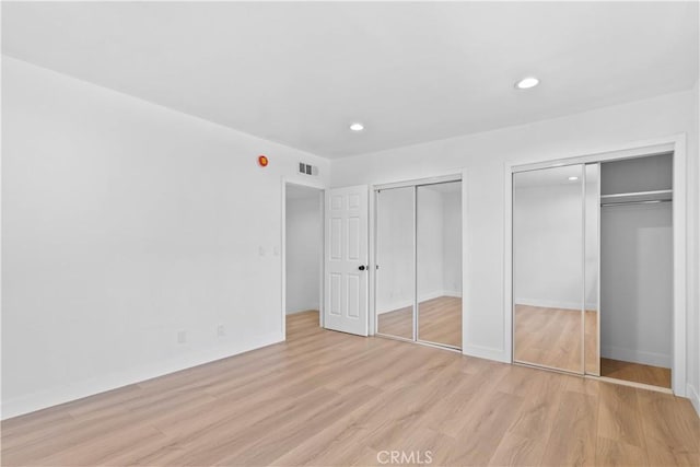9019 Cedros Ave Unit 2, Panorama City, CA 91402 - unfurnished bedroom with multiple closets, light wood-type flooring, and recessed lighting