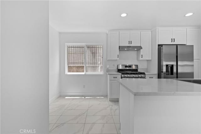 9019 Cedros Ave Unit 2, Panorama City, CA 91402 - kitchen with stainless steel appliances, under cabinet range hood, light marble finish floors, recessed lighting, and white cabinets