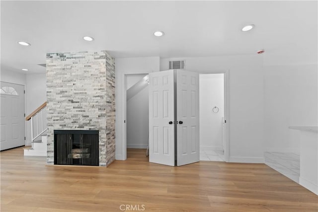 9019 Cedros Ave Unit 2, Panorama City, CA 91402 - unfurnished living room with wood finished floors, recessed lighting, stairway, and a fireplace