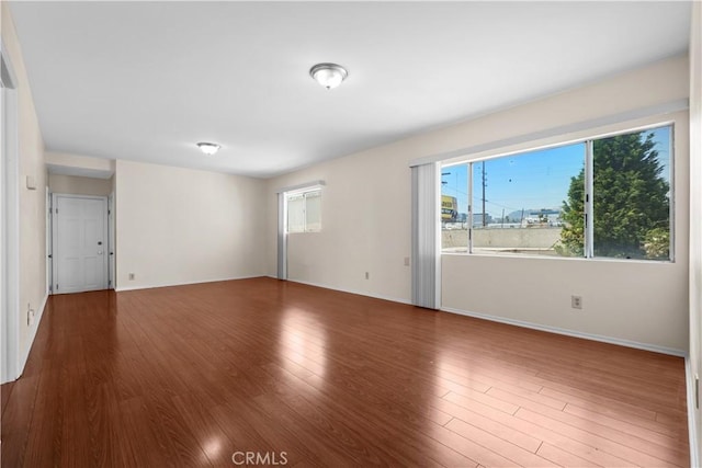 1067 N Wilton Pl, Los Angeles, CA 90038 - unfurnished room featuring wood finished floors and baseboards