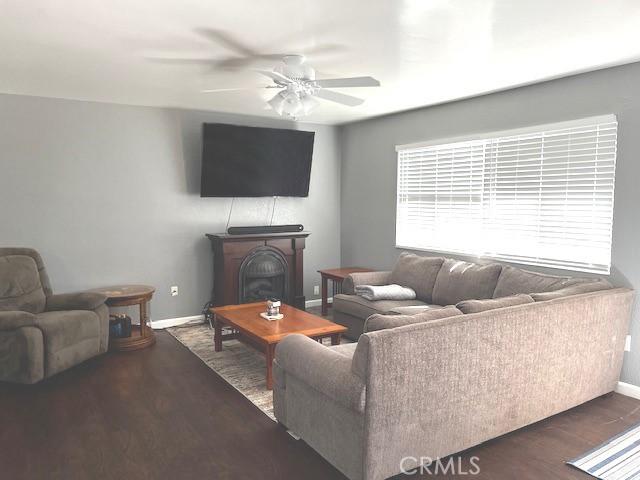 235 S 2nd St, Shandon, CA 93461 - living area with a ceiling fan, a fireplace, and wood finished floors