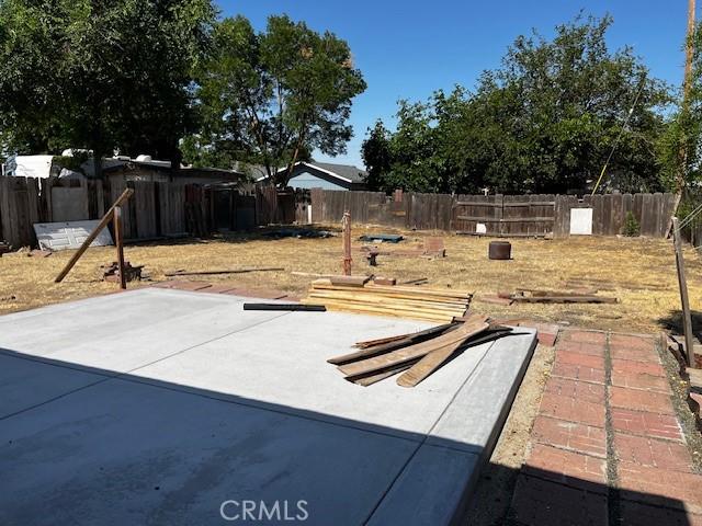 235 S 2nd St, Shandon, CA 93461 - fenced backyard featuring a patio area