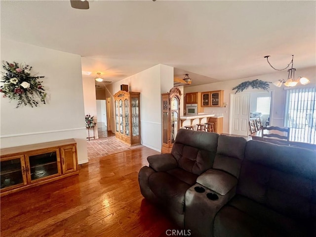 21509 Stage Dr, Tehachapi, CA 93561 - living room with light wood finished floors, a chandelier, and ceiling fan