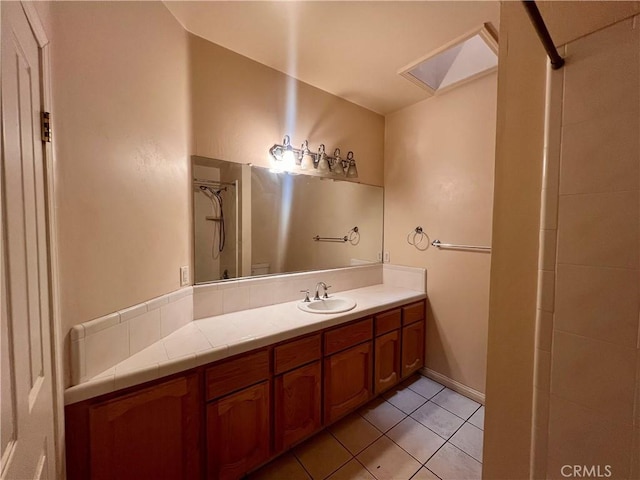 21509 Stage Dr, Tehachapi, CA 93561 - bathroom featuring a skylight, tile patterned floors, and vanity