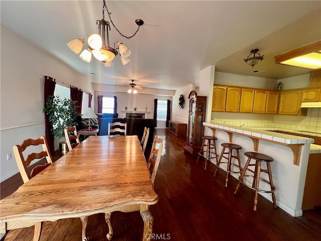 21509 Stage Dr, Tehachapi, CA 93561 - dining room with dark wood-style flooring, a chandelier, and a ceiling fan
