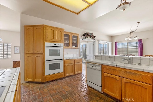 21509 Stage Dr, Tehachapi, CA 93561 - kitchen featuring white appliances, a chandelier, brick floors, glass insert cabinets, and tile countertops