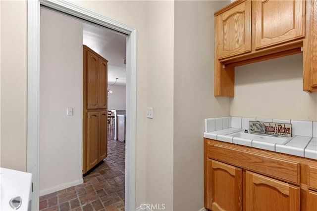 21509 Stage Dr, Tehachapi, CA 93561 - laundry area featuring brick flooring and a sink
