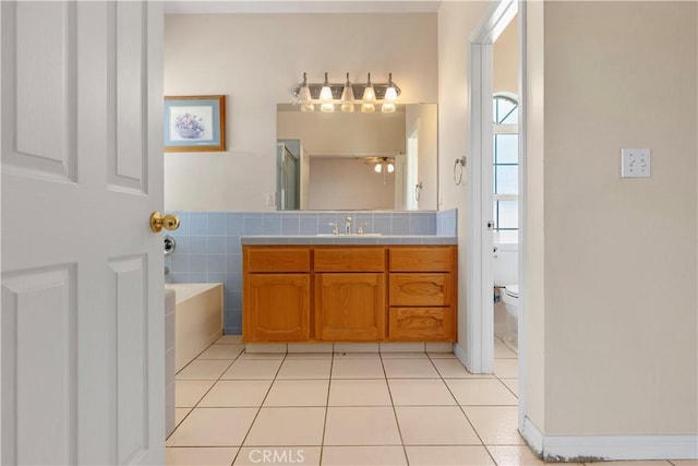 21509 Stage Dr, Tehachapi, CA 93561 - full bath featuring vanity, a garden tub, tile patterned flooring, and a ceiling fan