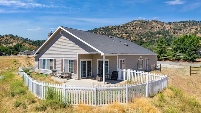 21509 Stage Dr, Tehachapi, CA 93561 - rear view of property with a mountain view, a patio, a chimney, and a fenced backyard