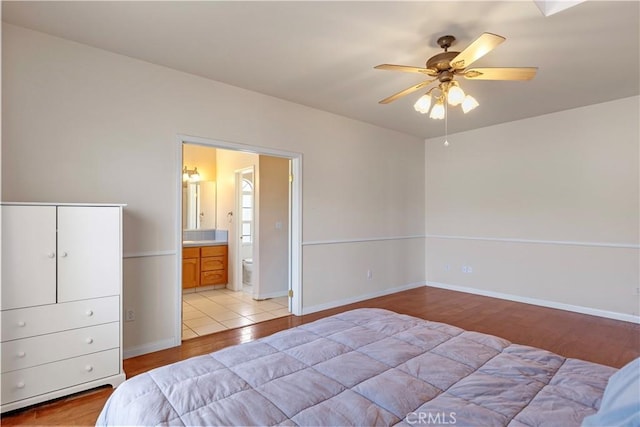 21509 Stage Dr, Tehachapi, CA 93561 - bedroom featuring light wood finished floors, ensuite bath, and ceiling fan