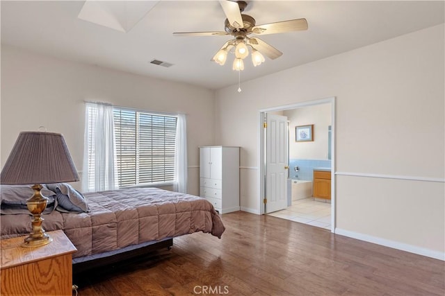 21509 Stage Dr, Tehachapi, CA 93561 - bedroom featuring light wood-style flooring, ensuite bath, and ceiling fan