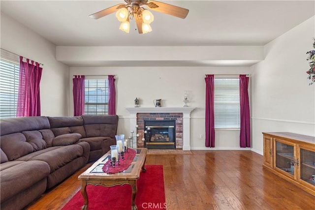 21509 Stage Dr, Tehachapi, CA 93561 - living area featuring wood finished floors, a ceiling fan, and a glass covered fireplace