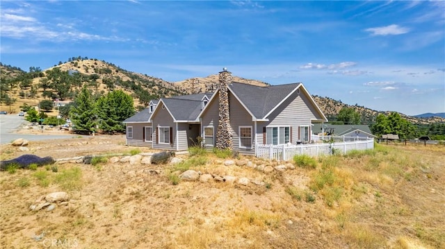 21509 Stage Dr, Tehachapi, CA 93561 - back of house featuring a mountain view and a chimney
