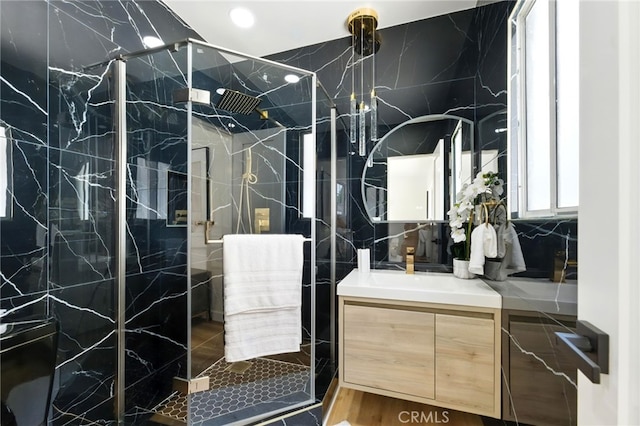 6119 Longridge Ave, Valley Glen, CA 91401 - bathroom featuring vanity, a marble finish shower, tile walls, and recessed lighting