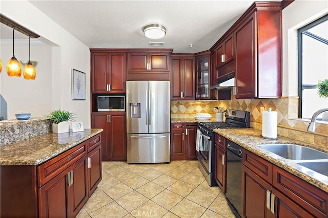5066 N Nearglen Ave, Covina, CA 91724 - kitchen with stainless steel appliances, reddish brown cabinets, decorative backsplash, under cabinet range hood, and pendant lighting