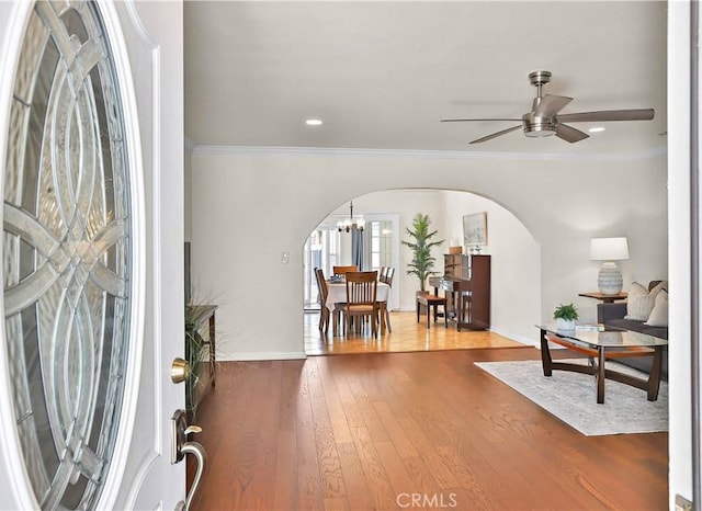 5066 N Nearglen Ave, Covina, CA 91724 - entryway featuring arched walkways, a ceiling fan, wood finished floors, crown molding, and a chandelier