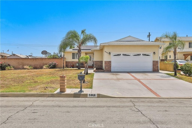 5066 N Nearglen Ave, Covina, CA 91724 - single story home with stucco siding, an attached garage, concrete driveway, solar panels, and stone siding