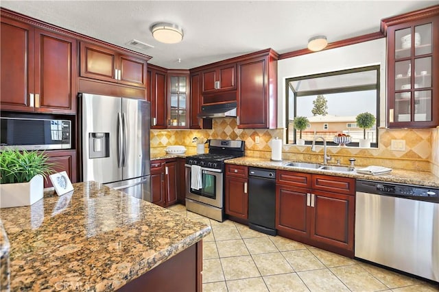 5066 N Nearglen Ave, Covina, CA 91724 - kitchen with appliances with stainless steel finishes, dark brown cabinets, under cabinet range hood, and backsplash