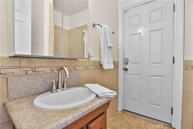5066 N Nearglen Ave, Covina, CA 91724 - bathroom featuring vanity, a shower with shower door, and tile walls