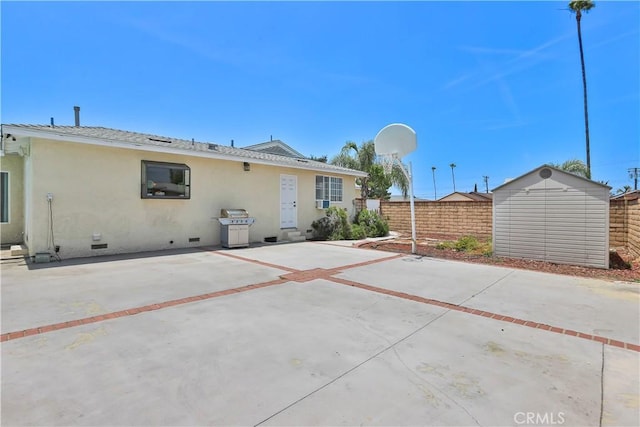 5066 N Nearglen Ave, Covina, CA 91724 - rear view of property with crawl space, stucco siding, a patio, and a storage unit