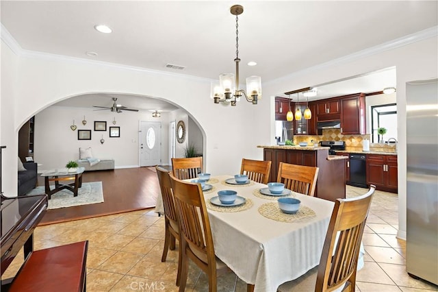 5066 N Nearglen Ave, Covina, CA 91724 - dining area with arched walkways, crown molding, a ceiling fan, a chandelier, and light tile patterned flooring