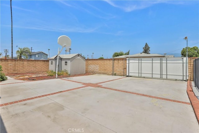 5066 N Nearglen Ave, Covina, CA 91724 - fenced backyard with a storage unit, a patio, and driveway