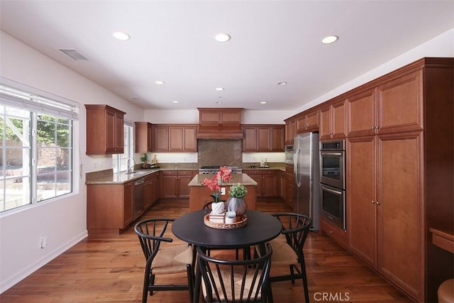 15681 Canon Ln, Chino Hills, CA 91709 - kitchen with stainless steel appliances, recessed lighting, a kitchen island, hardwood / wood-style flooring, and brown cabinetry