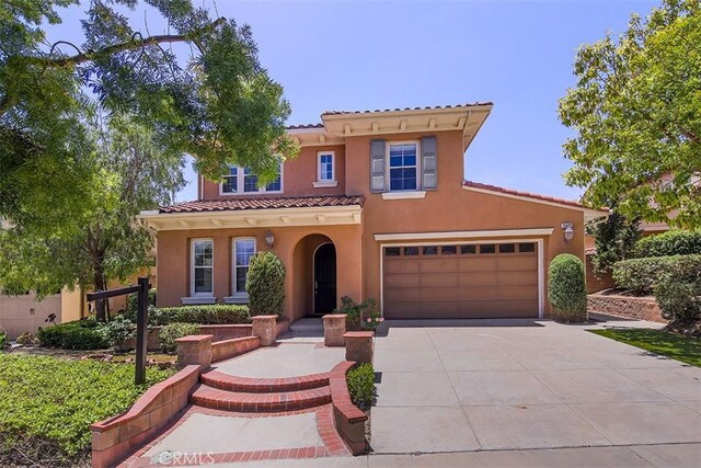 15681 Canon Ln, Chino Hills, CA 91709 - mediterranean / spanish home with stucco siding, concrete driveway, a tile roof, and a garage