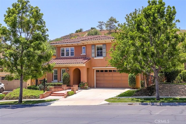 15681 Canon Ln, Chino Hills, CA 91709 - mediterranean / spanish home featuring a tiled roof, an attached garage, driveway, and stucco siding