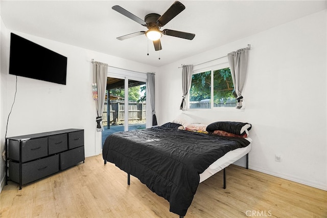 342 Rio Vista Ct, Corning, CA 96021 - bedroom with access to exterior, wood finished floors, and ceiling fan
